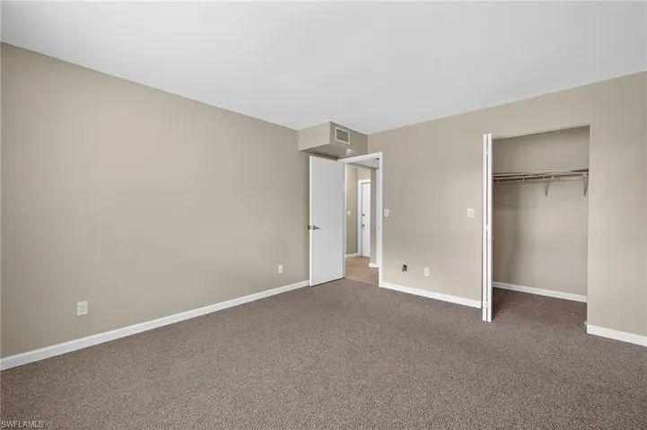Unfurnished bedroom featuring carpet and a closet