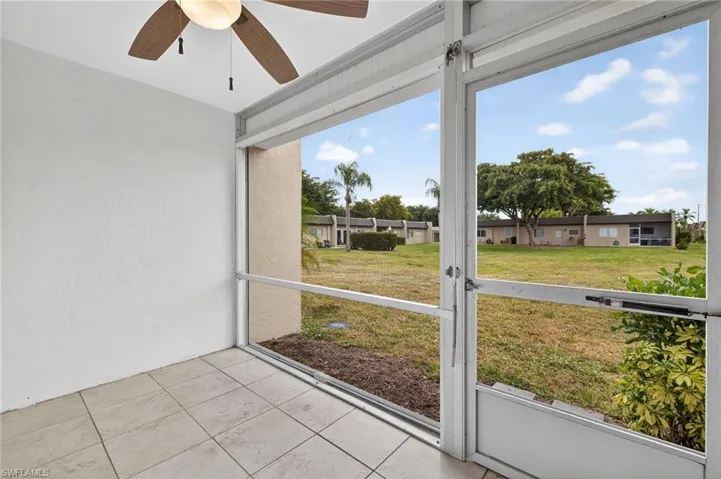 Unfurnished sunroom featuring ceiling fan