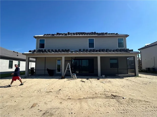 Rear view of property with central AC