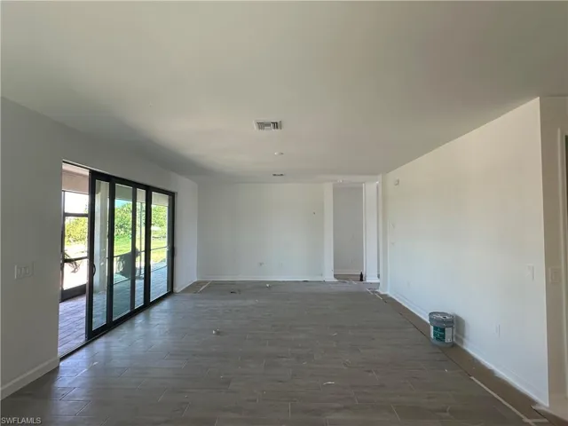 Empty room featuring dark wood-type flooring