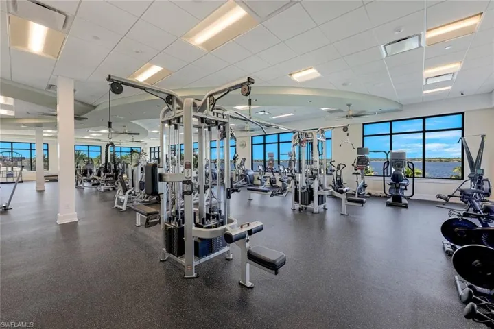Exercise room featuring plenty of natural light, visible vents, and ceiling fan