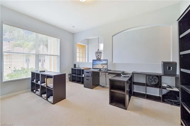 Office featuring light carpet and baseboards