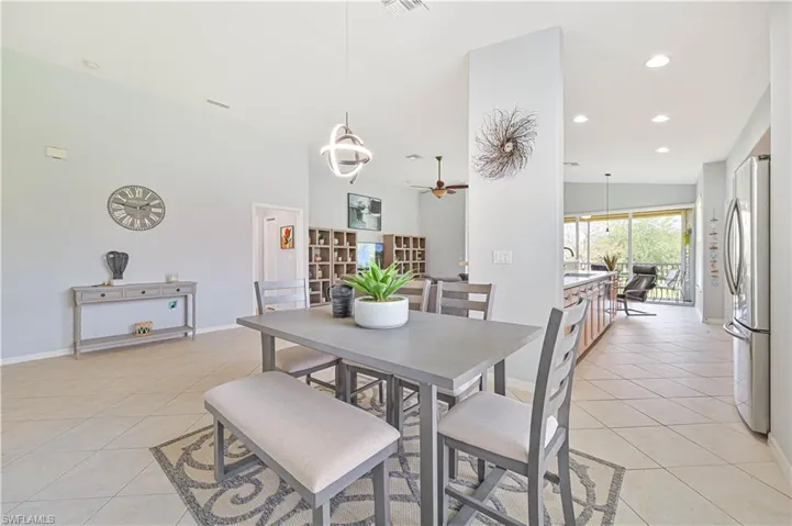 Dining area with recessed lighting, ceiling fan, and light tile patterned floors