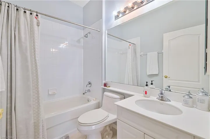 Bathroom with vanity and shower / bathtub combination with curtain