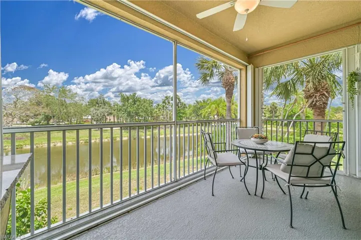 Sunroom featuring carpet flooring and a water view