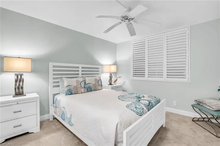 Carpeted bedroom with ceiling fan