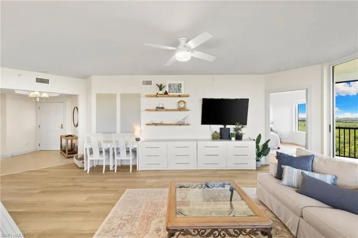 Living area featuring light wood finished floors and a ceiling fan