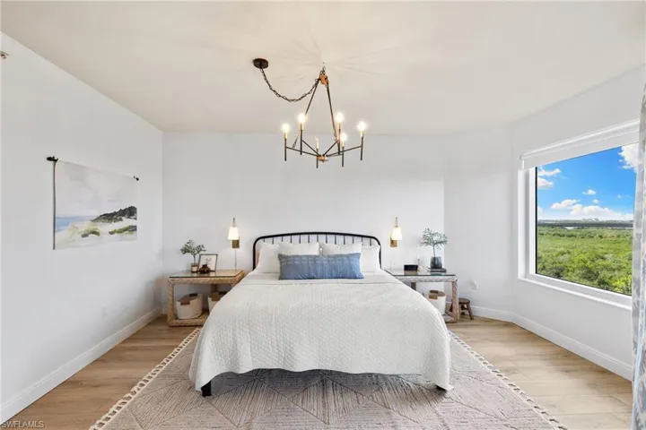 Bedroom with light wood-style floors and a chandelier