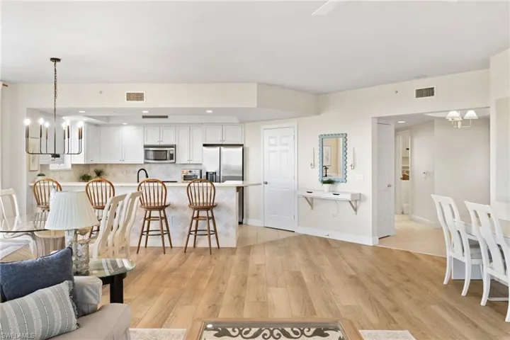 Living room featuring a chandelier, light wood finished floors, and recessed lighting