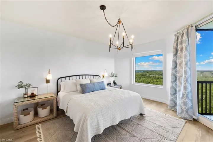 Bedroom with light wood-style floors and a chandelier