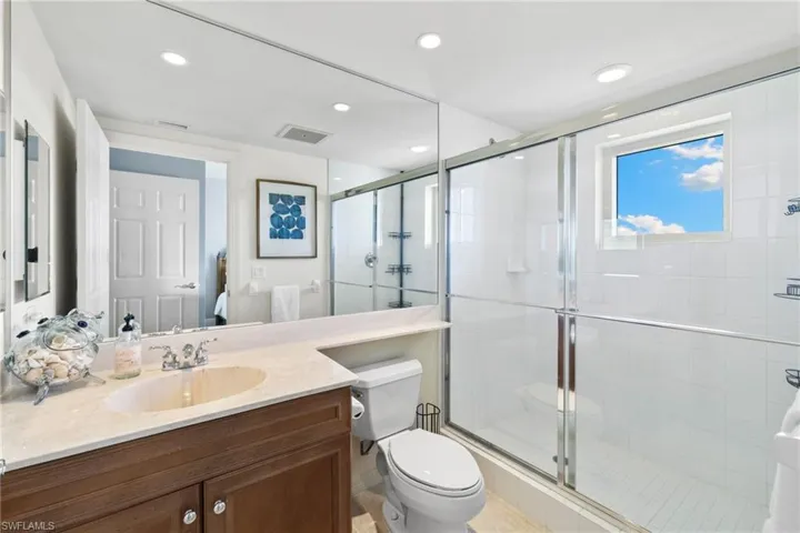 Bathroom featuring vanity, a stall shower, and recessed lighting