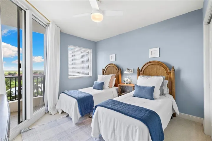 Bedroom featuring access to outside, carpet floors, and ceiling fan