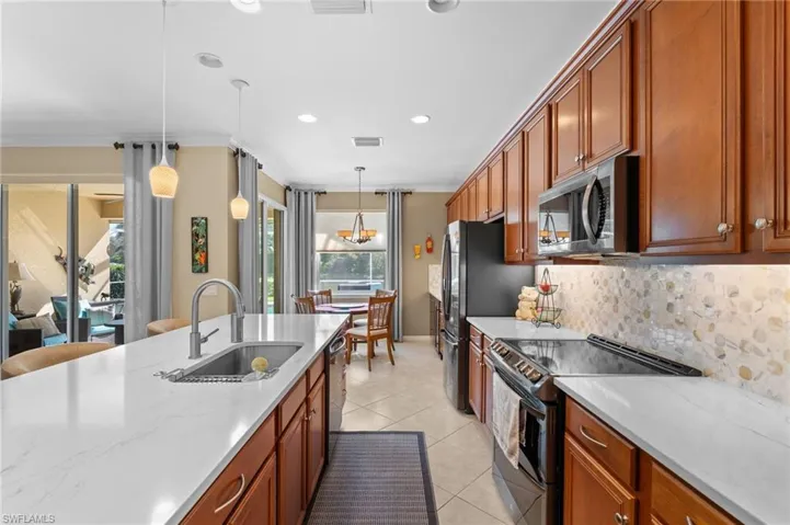 Large, updated kitchen with quartz countertop, pantry, wine refrigerator, plenty of storage.