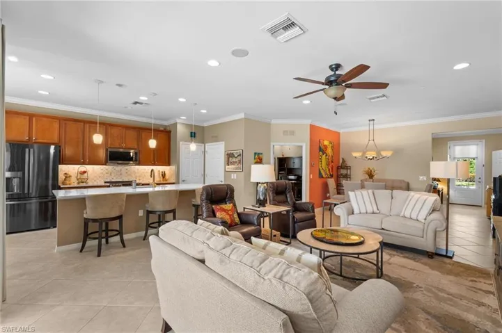 Open floorplan with large great room, dining, kitchen island.