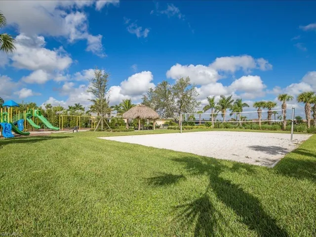 View of community with a lawn, playground community, a gazebo, and volleyball court
