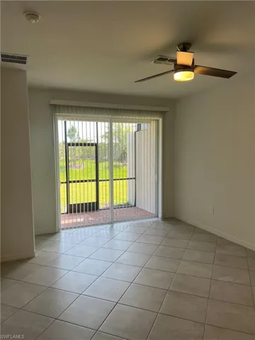 Unfurnished room featuring visible vents, ceiling fan, light tile patterned flooring, and baseboards
