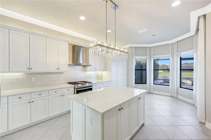 Kitchen with healthy amount of natural light and light tile patterned floors