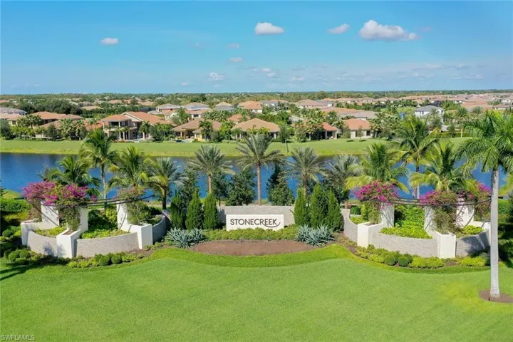 Aerial perspective of suburban area featuring a large body of water