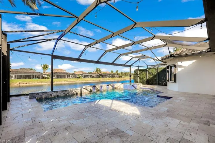 View of swimming pool with connected hot tub