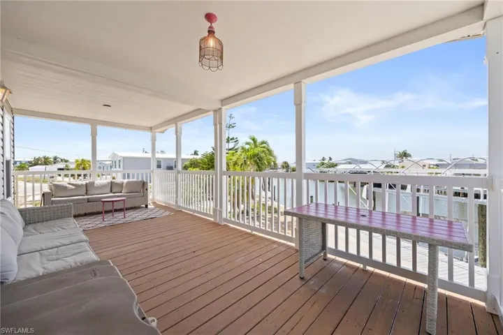 Expansive covered porch facing the canal for a great entertaining space.