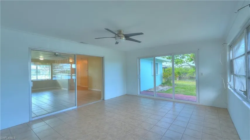 Tiled flooring throughout with a ceiling fan
