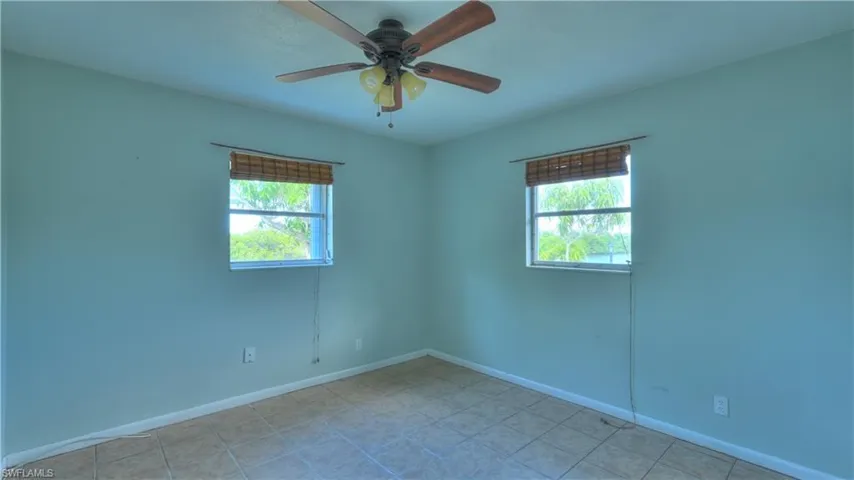 Room with light blue painted walls and neutral-toned tile flooring