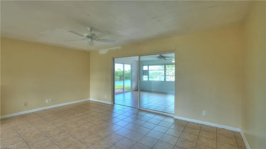 Spacious room featuring neutral tone walls and large format tile flooring