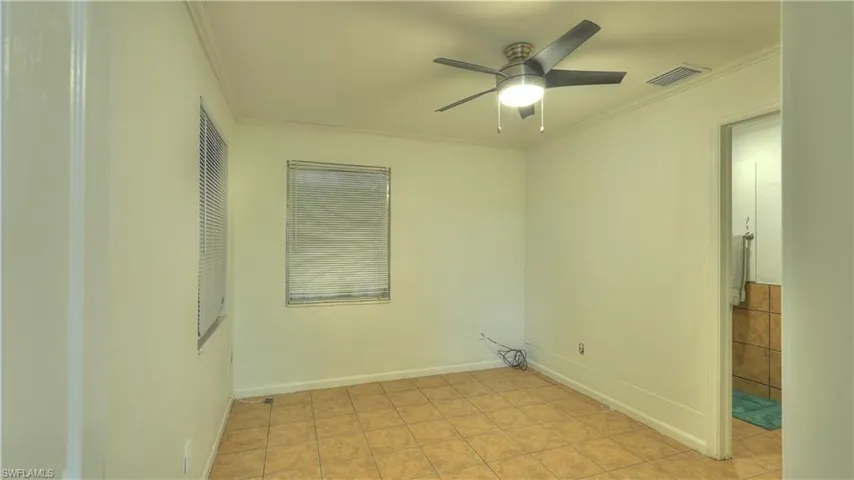 Neutral-toned walls complement the tile flooring