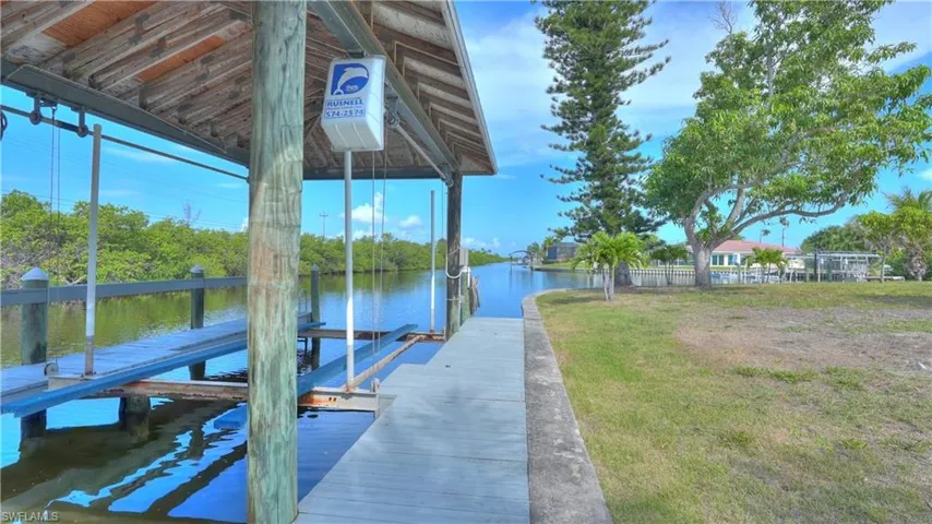Waterfront property featuring a covered boat dock with a lift system
