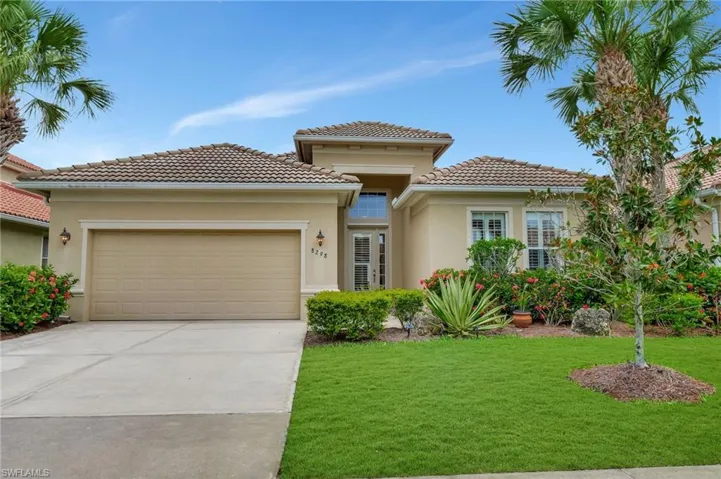 Mediterranean / spanish-style house featuring a garage and a front lawn