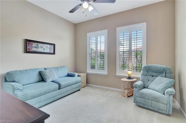 Guest bedroom featuring ceiling fan and carpet flooring
