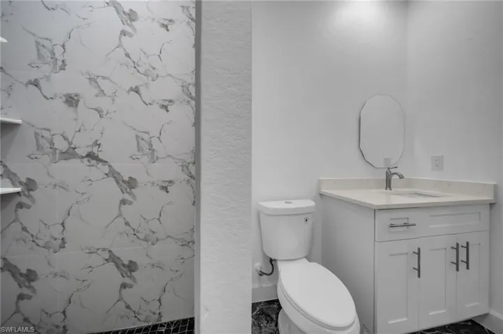 Full bathroom with toilet and vanity