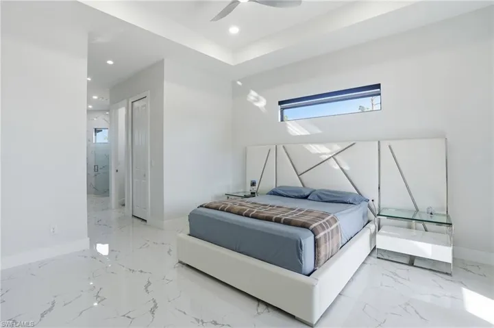 Bedroom with multiple windows, a closet, a ceiling fan, and recessed lighting