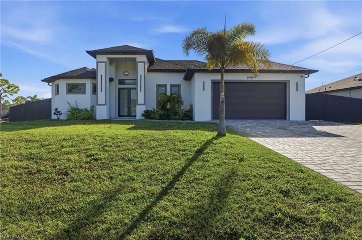 View of front of property featuring decorative driveway, stucco siding, a garage, and a shingled roof