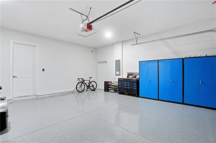 Garage with electric panel and a garage door opener