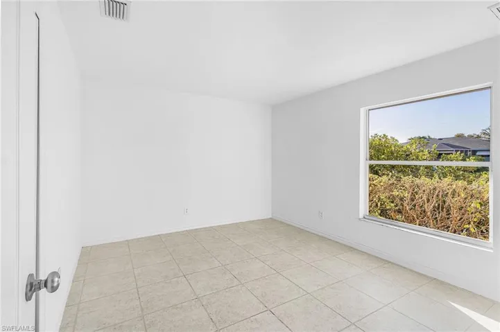 Spare room with light tile patterned floors