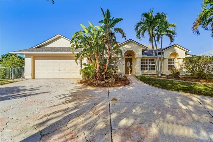 Single story home featuring driveway, an attached garage, stucco siding, and roof with shingles