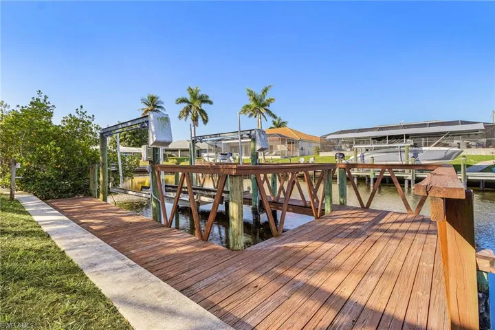 Dock area with boat lift and a water view