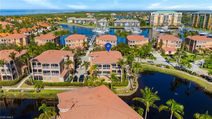 Birds eye view of property with a water view and a residential view