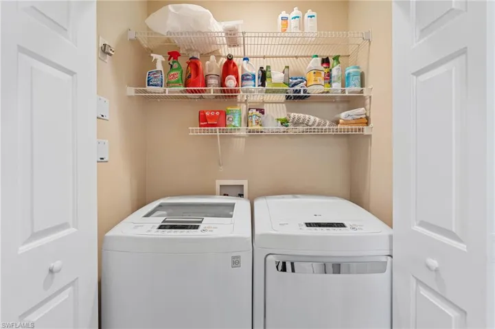 Washroom with washing machine and dryer and laundry area