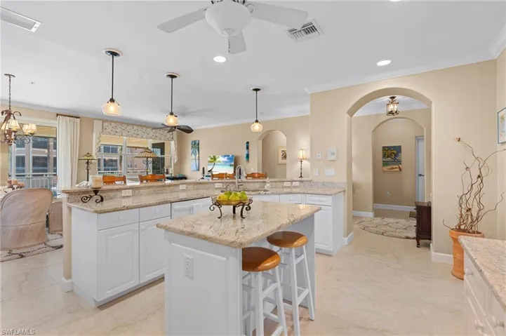 Kitchen with a sink, white dishwasher, visible vents, and arched walkways