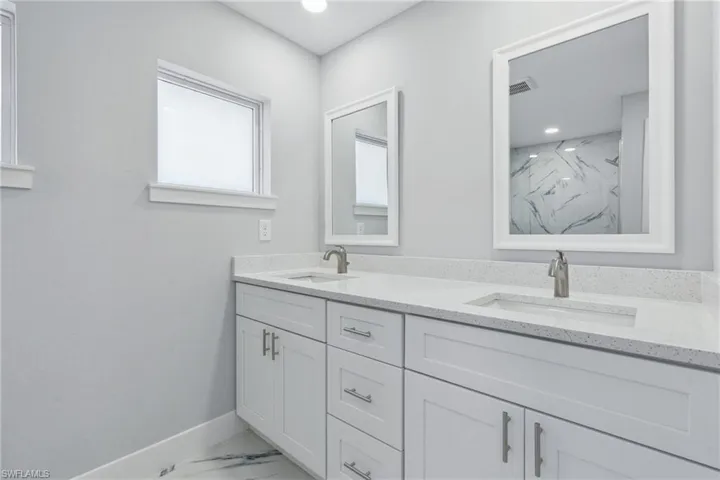 Bathroom featuring large vanity and dual sinks