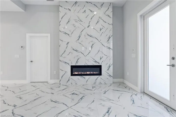 Room details featuring tile flooring and a fireplace