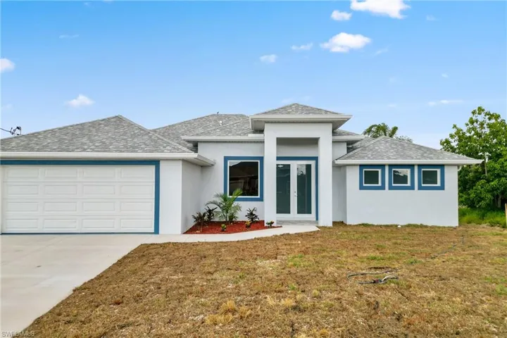 Prairie-style house with a front yard and a garage