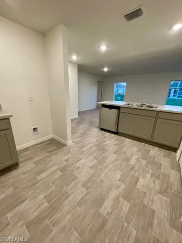 Laundry room with light wood-type flooring and recessed lighting