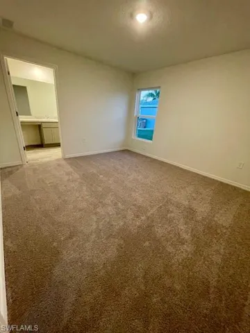 Unfurnished bedroom with carpet and a textured ceiling