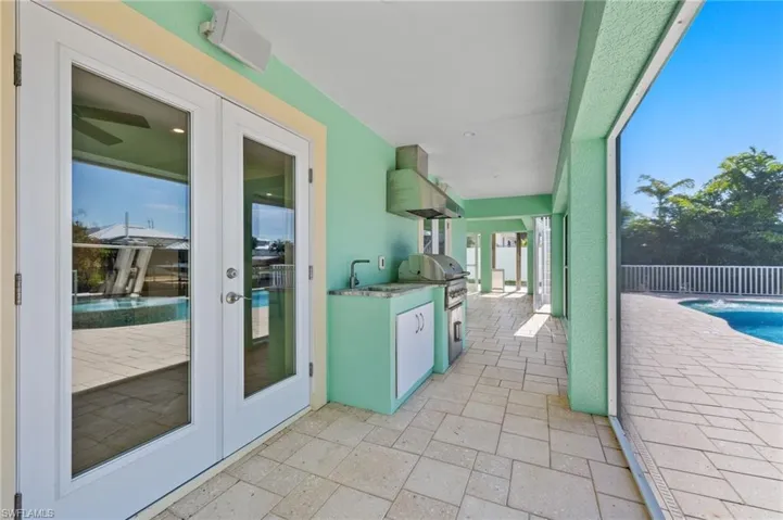 Just outside of the bonus room is a cooking area with built in propane grill and sink.