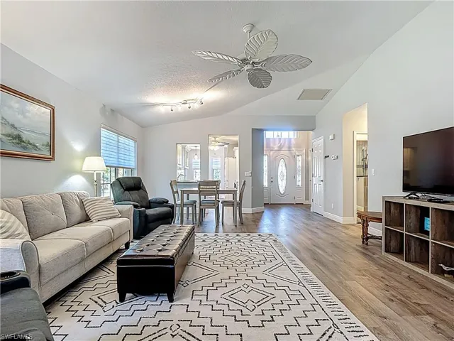 Living area with a ceiling fan and light wood finished floors