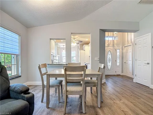 Dining space with light wood-style floors and ceiling fan