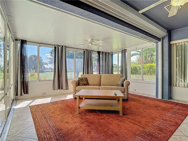 Sunroom with tile patterned flooring and baseboards